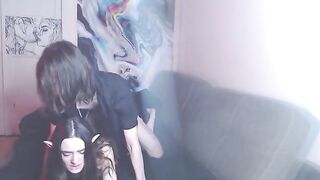 A couple enjoys intimate moments while listening to music on the couch