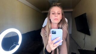 The blonde fucks with her phone in her hand, capturing every moment