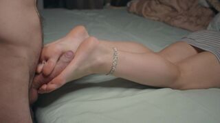 A petite woman shows off her small feet and performs a foot job