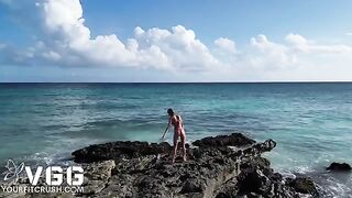 A young girl is having fun naked on the beach