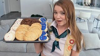 The girl is motivated to sell cookies, no matter by any means