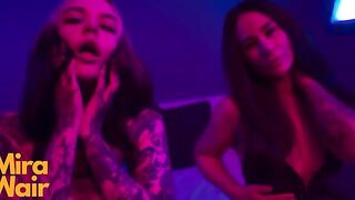 Two girls in dresses have fun with a man using a huge dildo