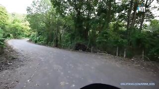 A girl is having her first ride on a motorbike with a stranger in the jungle