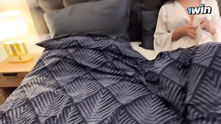 A hot stepmom is sharing a bed with her stepson on a rainy night