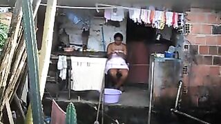 A hidden camera has been set up in the room, and a black woman is unaware of it