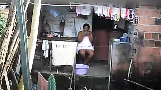 A hidden camera has been set up in the room, and a black woman is unaware of it