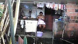 A hidden camera has been set up in the room, and a black woman is unaware of it