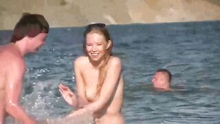 A mature woman enjoys sunbathing naked on the beach