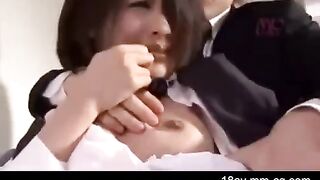 An Asian guy is painting the wall when his sister comes in wearing only a T-shirt