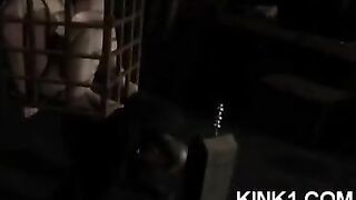 A slave in a cage is forced to fulfill all the orders of the mistress