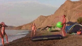 A hot chick is playing badminton naked on the nudist beach