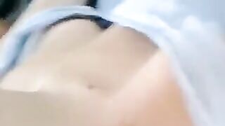 A half-naked girl is lying and stroking her body with her hands