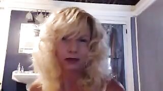 A nice woman aged has a pleasant time in the bathroom with her toy