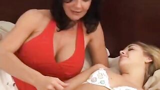 A young girl is having fun with her older girlfriend in bed