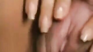 A girl with a big hairy clitoris plays with it and moans with pleasure