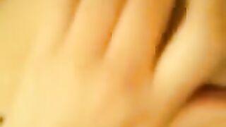 A beautiful woman has an intense orgasm after pleasuring herself, showcasing her juicy allure