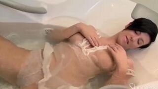 A lonely brunette woman caresses herself under the shower stream