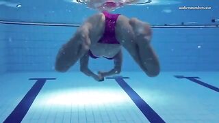 A hot girl is swimming naked in the pool