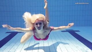 A hot girl is swimming naked in the pool