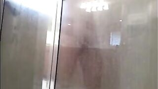 The man washes his body in the shower, but there’s a camera