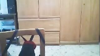 A woman fucks in front of the webcam, her husband is nearby