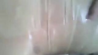 A guy puts a condom on his dick and jerks it