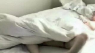 A girl was masturbating in bed, not knowing there was a camera