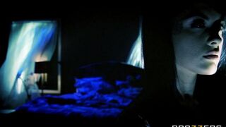 A brunette woman is having sex with her husband in the bedroom