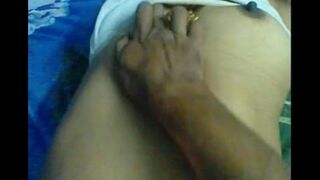 The husband gently massages the nipples of his wife’s boobs