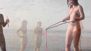 A girl is fucking on the public beach without any clothes