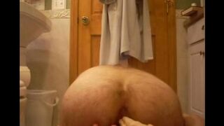 A woman enjoys intense anal play with a rubber phallus in this homemade scene