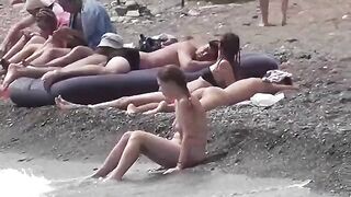 Nudist couple enjoying romantic sex on the beach