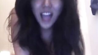 Asian beauty fucks with herself on her bed in a steamy webcam session