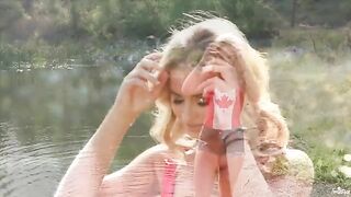 Blonde tenderly masturbating herself by the lake
