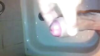 The kid caresses his dick with his hand in the shower