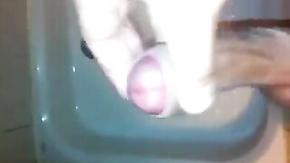 The kid caresses his dick with his hand in the shower