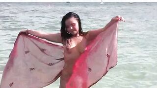 A hot girl has a bath and plays with herself on the coast