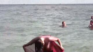 A hot girl has a bath and plays with herself on the coast