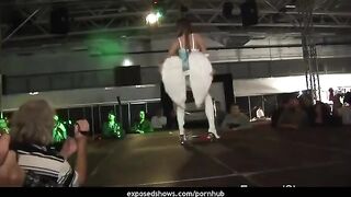 A hot brunette learns to work with a strip pole and removes her clothes