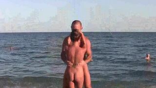 Acrobats have fun on the naked beach