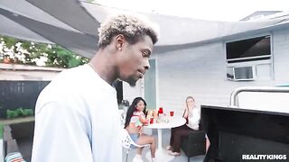 A black guy has sex with a girl at the BBQ in the park