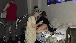 A cute girl has sex with two guys at a party, showcasing her petite frame in action