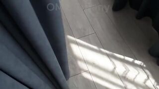 A cute girl rolls on a bed sheet like a storm